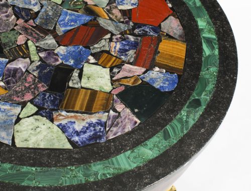 fig 3. A circular early 20th-century Italian occasional table featuring a colourful pietra dura inlaid stone top supported by three brass columns on a mahogany triform base.