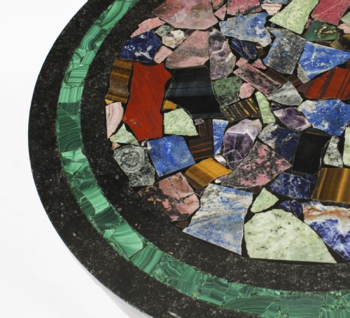 fig 4. A circular early 20th-century Italian occasional table featuring a colourful pietra dura inlaid stone top supported by three brass columns on a mahogany triform base.