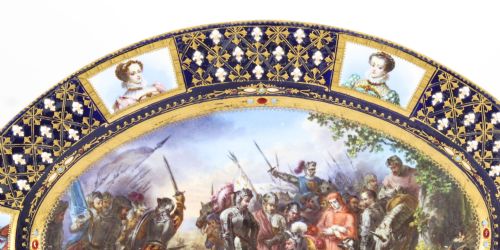 fig 3. An antique French oval porcelain dish featuring a central hand-painted historical battle scene surrounded by a cobalt blue border with gilt lattice work and portrait cartouches.