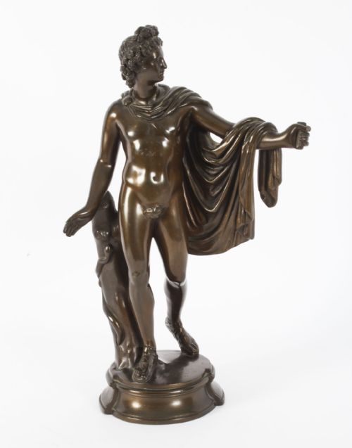 fig 2. A nineteenth-century dark brown bronze sculpture depicting the classical Greek god Apollo standing with draped cloth on a circular base.