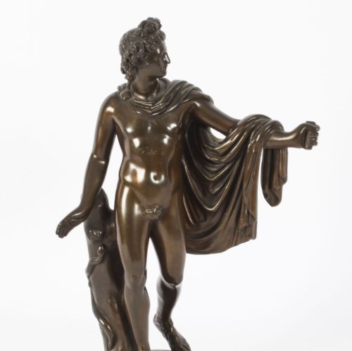 fig 3. A nineteenth-century dark brown bronze sculpture depicting the classical Greek god Apollo standing with draped cloth on a circular base.