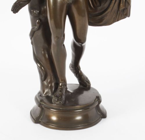 fig 5. A nineteenth-century dark brown bronze sculpture depicting the classical Greek god Apollo standing with draped cloth on a circular base.