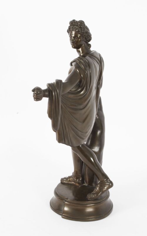 fig 8. A nineteenth-century dark brown bronze sculpture depicting the classical Greek god Apollo standing with draped cloth on a circular base.