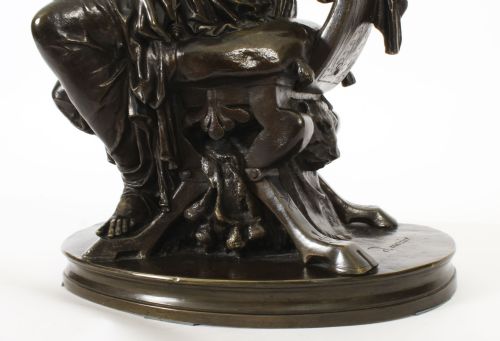 fig 7. A 19th-century dark patinated bronze sculpture depicting the classical goddess Diana seated on a chair with a bow and quiver, set upon an oval base.