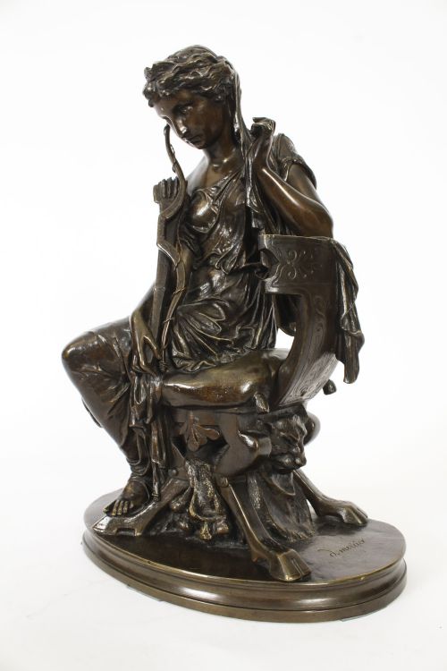 fig 9. A 19th-century dark patinated bronze sculpture depicting the classical goddess Diana seated on a chair with a bow and quiver, set upon an oval base.