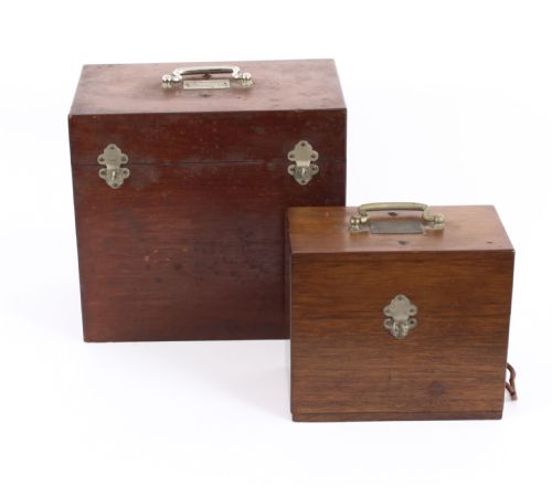 fig 1. A pair of open mahogany boxes containing early 20th-century French electrotherapy devices with brass switches and a green wire coil.