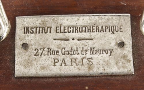 fig 3. A pair of open mahogany boxes containing early 20th-century French electrotherapy devices with brass switches and a green wire coil.