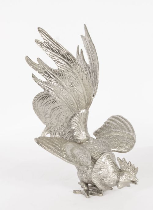 fig 4. A pair of silver-plated fighting cockerels facing each other in dynamic poses with detailed plumage.
