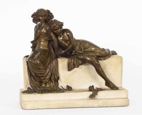 fig 1. A dark bronze sculpture depicting two classical draped figures resting on a light-coloured carved marble bench base.