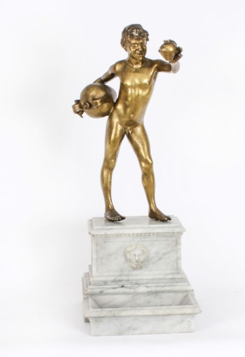 fig 1. A 19th-century bronze sculpture depicting a standing youth holding water vessels, mounted on a carved white marble fountain-style base.