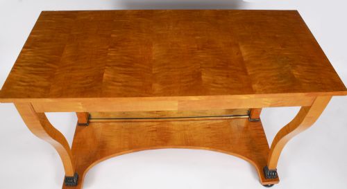 fig 2. A 19th-century Biedermeier console table featuring figured maserbirch veneer, a mirrored back panel, curved front legs with ebonised feet, and a concave lower shelf.