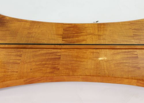 fig 5. A 19th-century Biedermeier console table featuring figured maserbirch veneer, a mirrored back panel, curved front legs with ebonised feet, and a concave lower shelf.