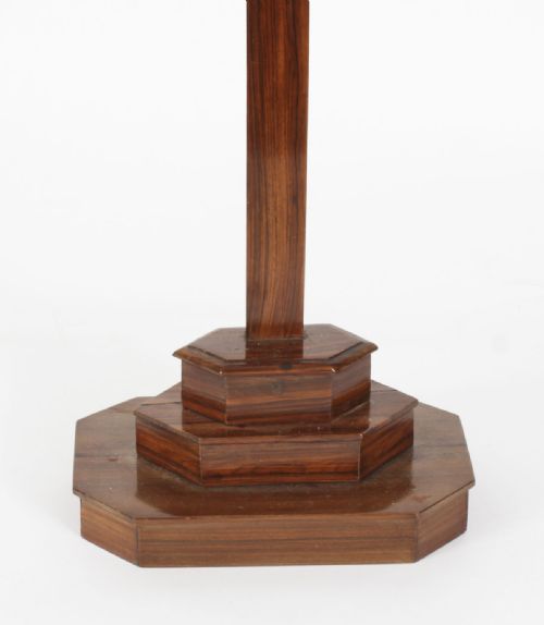 fig 4. A carved wooden Corpus Christi mounted on a dark olive wood cross with an INRI scroll, supported by a tiered hexagonal wooden base.