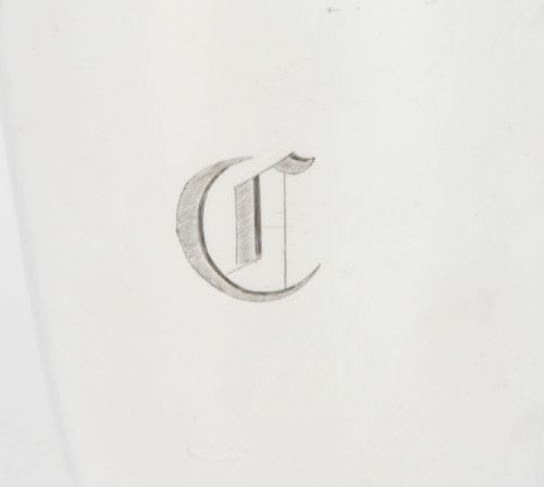 fig 1. An Art Deco silver plated cocktail shaker featuring an engraved monogram letter D and a top section with a recipe viewing window.