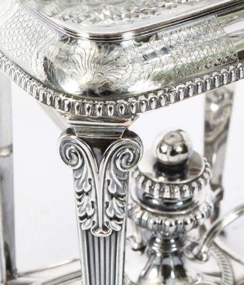 fig 2. An early nineteenth-century Old Sheffield plate and cut glass epergne centrepiece featuring four branching arms holding smaller crystal dishes beneath a large central glass bowl.
