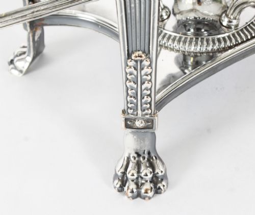 fig 3. An early nineteenth-century Old Sheffield plate and cut glass epergne centrepiece featuring four branching arms holding smaller crystal dishes beneath a large central glass bowl.