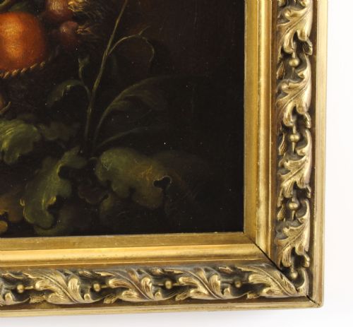fig 7. An 18th-century oil painting depicting two boys with a dog and fruit, housed within a gilded frame with a scrolled top crest.