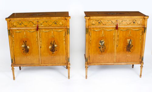 fig 1. A pair of 19th-century Adam Revival satinwood side cabinets featuring hand-painted classical swags, musical trophies, and slender turned legs.