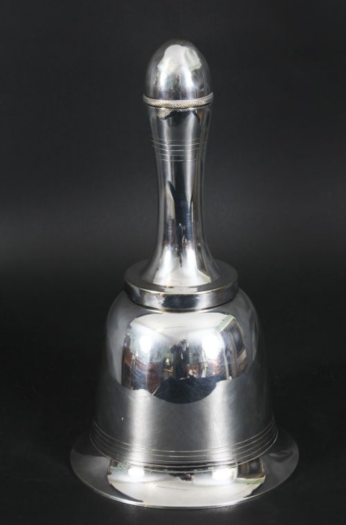 fig 5. A silver-plated Art Deco cocktail shaker shaped like a handbell with a polished metal finish.