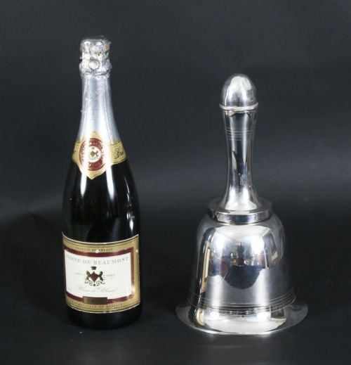 fig 7. A silver-plated Art Deco cocktail shaker shaped like a handbell with a polished metal finish.