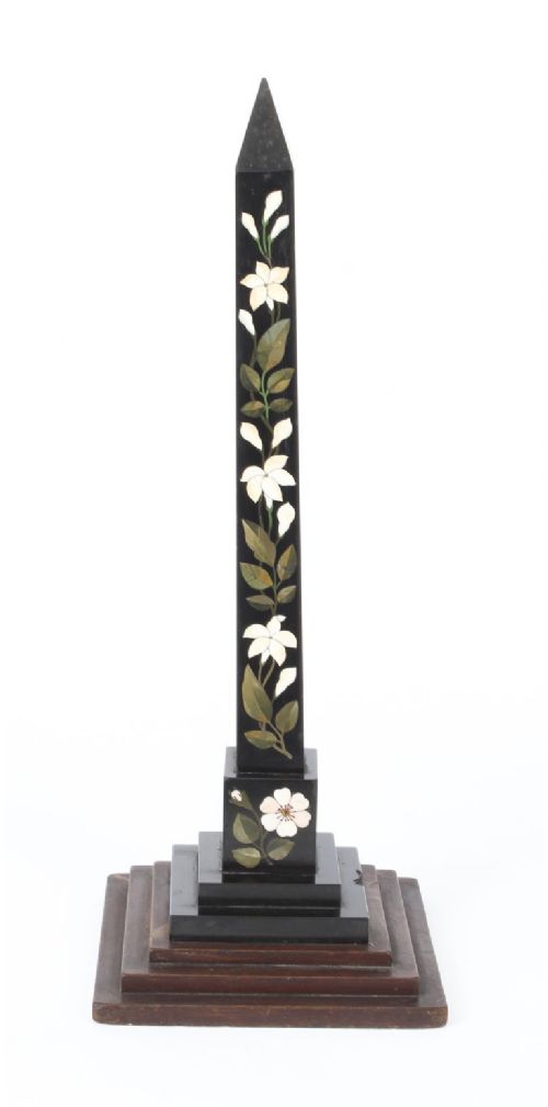 fig 1. A nineteenth-century Victorian black marble obelisk featuring floral pietra dura stone inlay, set upon a stepped square wooden base.