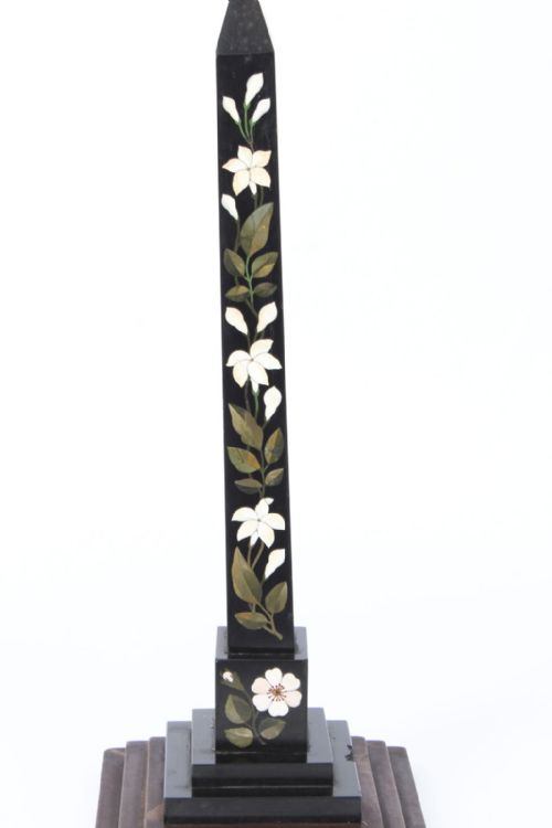 fig 2. A nineteenth-century Victorian black marble obelisk featuring floral pietra dura stone inlay, set upon a stepped square wooden base.