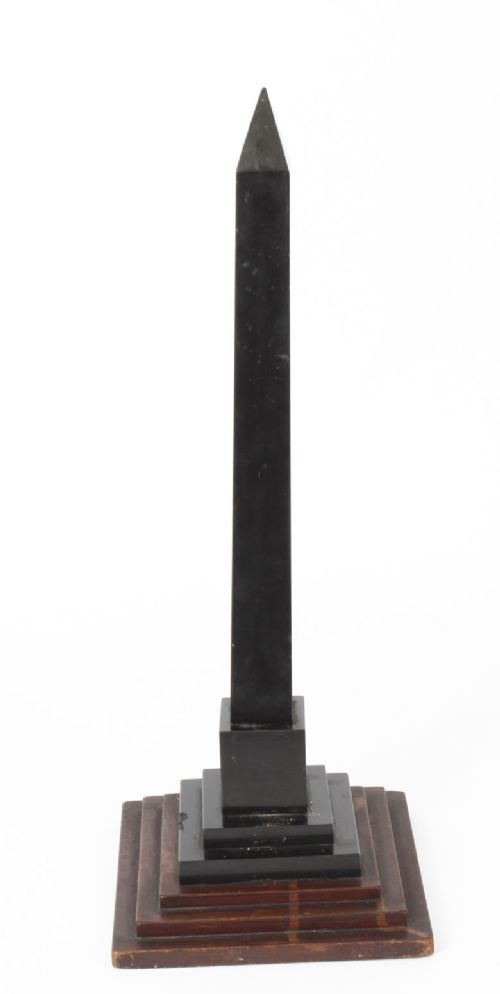 fig 4. A nineteenth-century Victorian black marble obelisk featuring floral pietra dura stone inlay, set upon a stepped square wooden base.