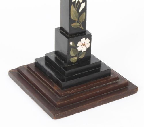 fig 5. A nineteenth-century Victorian black marble obelisk featuring floral pietra dura stone inlay, set upon a stepped square wooden base.