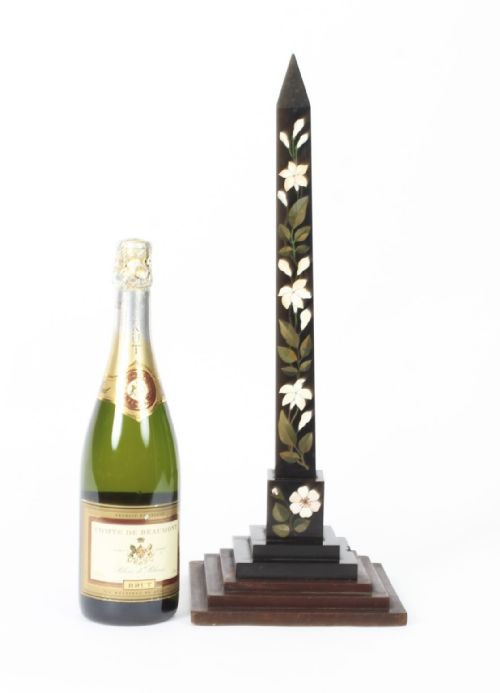 fig 6. A nineteenth-century Victorian black marble obelisk featuring floral pietra dura stone inlay, set upon a stepped square wooden base.