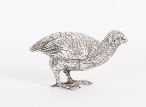 fig 1. A pair of 19th-century silver game bird figurines depicting grouse with detailed chased feather texturing.