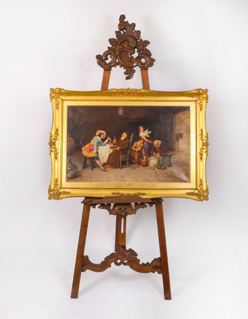 fig 2. An antique carved walnut artist easel featuring an ornate Rococo cresting, an adjustable shelf, and scrolled leg supports.