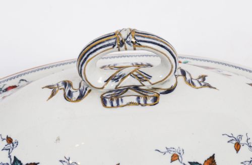 fig 2. A twenty-two piece antique Muller Volkstedt porcelain dinner service featuring white ground with floral borders, red rims, gold accents, including a large tureen, serving platters, and plates.