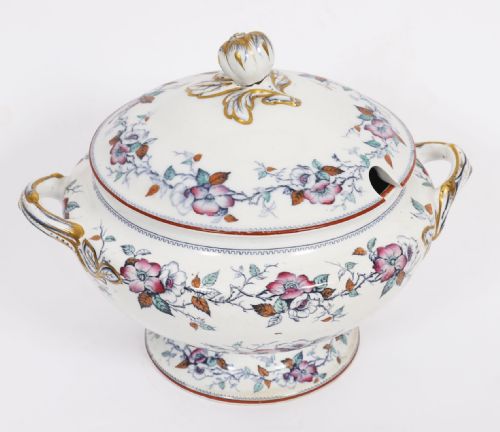 fig 3. A twenty-two piece antique Muller Volkstedt porcelain dinner service featuring white ground with floral borders, red rims, gold accents, including a large tureen, serving platters, and plates.