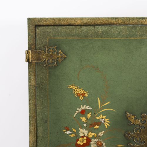 fig 3. A green lacquered two-door cocktail cabinet with hand-painted chinoiserie scenes resting on a carved silver gilt stand with cabriole legs.
