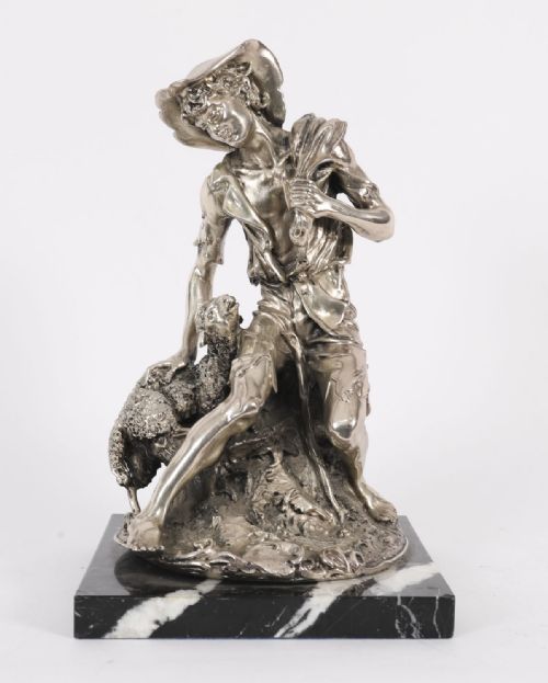 fig 1. A 19th-century silvered bronze sculpture depicting a young shepherd seated beside a lamb, mounted on a square black veined marble base.