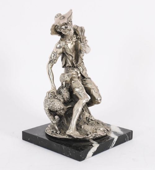 fig 2. A 19th-century silvered bronze sculpture depicting a young shepherd seated beside a lamb, mounted on a square black veined marble base.