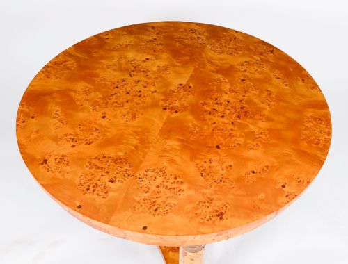 fig 2. A circular 20th-century Biedermeier revival coffee table made from burr elm with three column legs set on a triform plinth base.