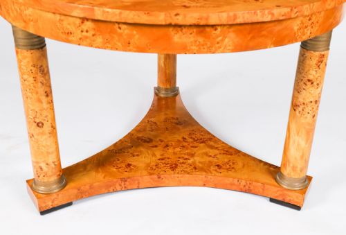 fig 6. A circular 20th-century Biedermeier revival coffee table made from burr elm with three column legs set on a triform plinth base.