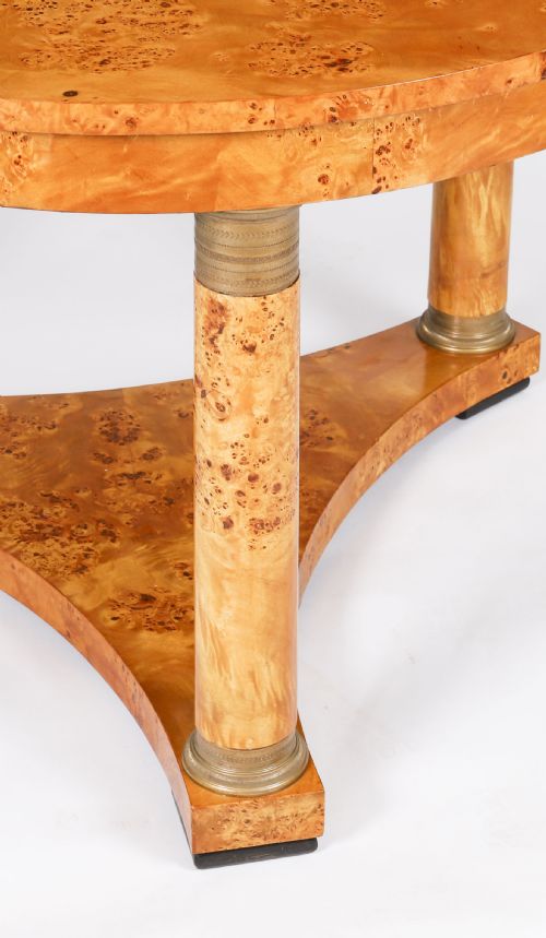 fig 8. A circular 20th-century Biedermeier revival coffee table made from burr elm with three column legs set on a triform plinth base.