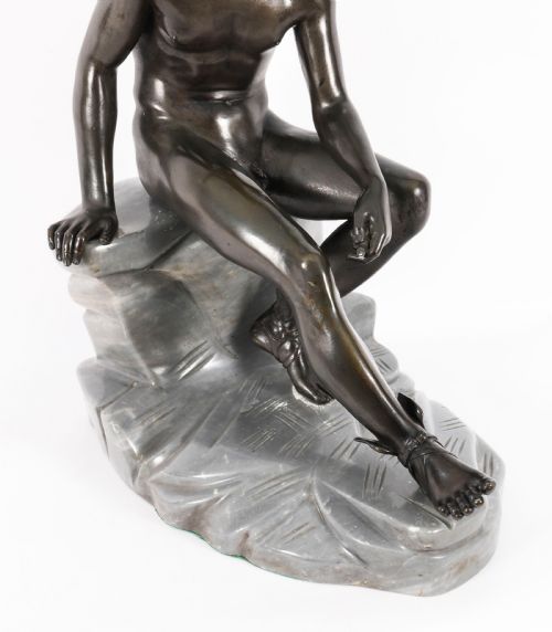 fig 4. A dark patinated bronze sculpture depicting a nude seated Hermes resting on a carved grey marble base.
