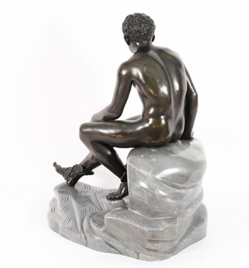 fig 6. A dark patinated bronze sculpture depicting a nude seated Hermes resting on a carved grey marble base.