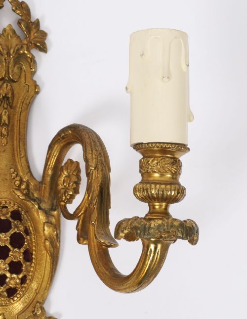 fig 2. A pair of 19th-century French gilt bronze twin-light wall appliques featuring floral cresting, acanthus leaf arms, and faux candle sleeves.