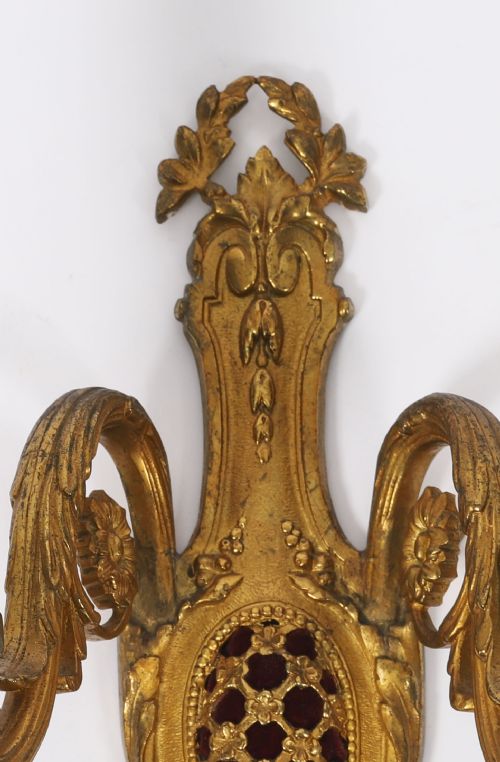 fig 3. A pair of 19th-century French gilt bronze twin-light wall appliques featuring floral cresting, acanthus leaf arms, and faux candle sleeves.