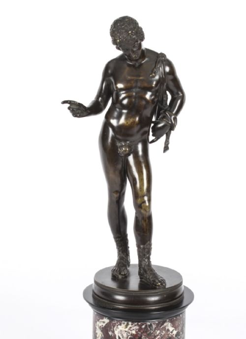 fig 1. A nineteenth-century dark patinated bronze statue of a classical nude youth standing in contrapposto on a circular veined marble pedestal base.