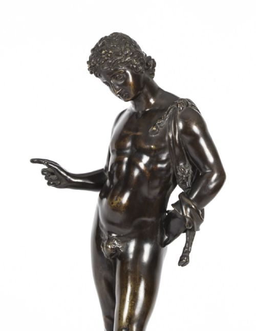 fig 2. A nineteenth-century dark patinated bronze statue of a classical nude youth standing in contrapposto on a circular veined marble pedestal base.