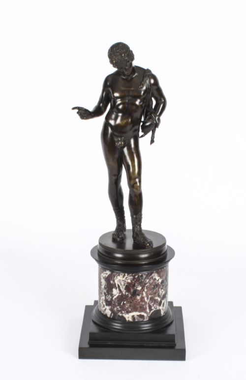 fig 3. A nineteenth-century dark patinated bronze statue of a classical nude youth standing in contrapposto on a circular veined marble pedestal base.