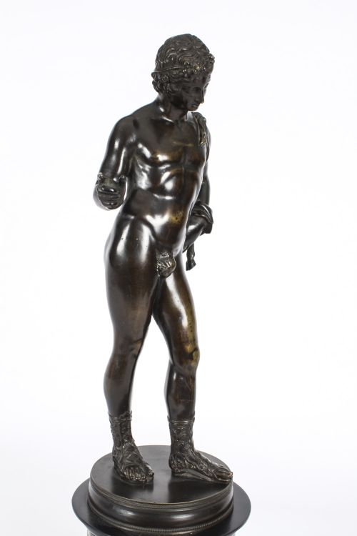 fig 4. A nineteenth-century dark patinated bronze statue of a classical nude youth standing in contrapposto on a circular veined marble pedestal base.