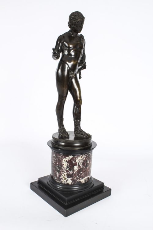 fig 5. A nineteenth-century dark patinated bronze statue of a classical nude youth standing in contrapposto on a circular veined marble pedestal base.