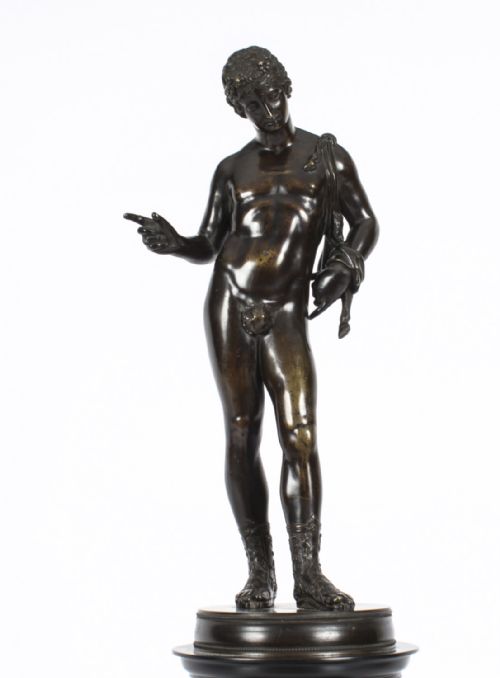 fig 6. A nineteenth-century dark patinated bronze statue of a classical nude youth standing in contrapposto on a circular veined marble pedestal base.