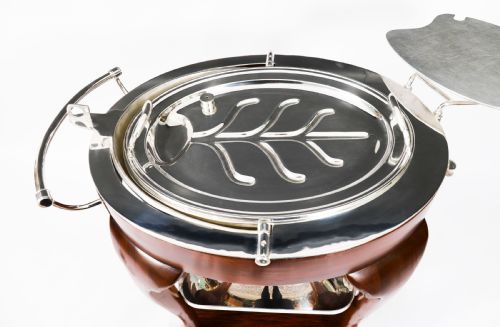 fig 5. An Art Deco silver-plated beef carving trolley with a hemispherical revolving dome cover mounted on a dark mahogany frame with cabriole legs.